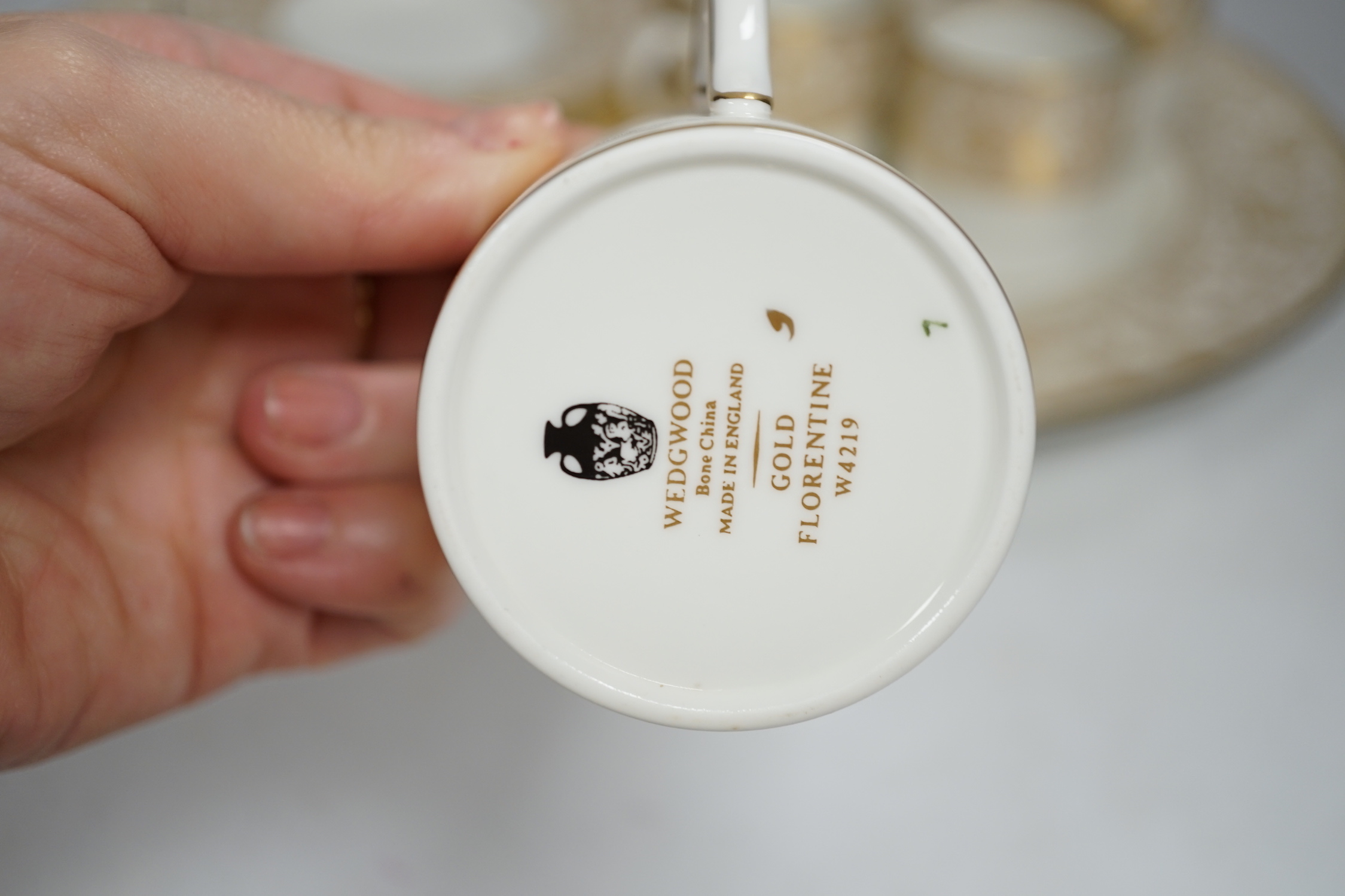 A Wedgwood Gold Florentine dinner and coffee service, mostly 8-12 settings, largest 39cm wide